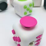 A group of different colored cubes on a white surface.