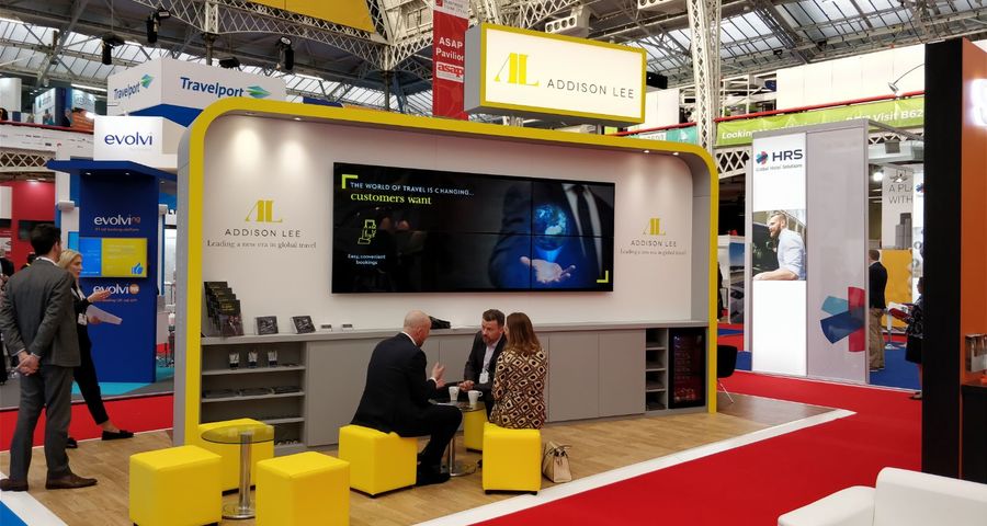 A group of people at a trade show booth.